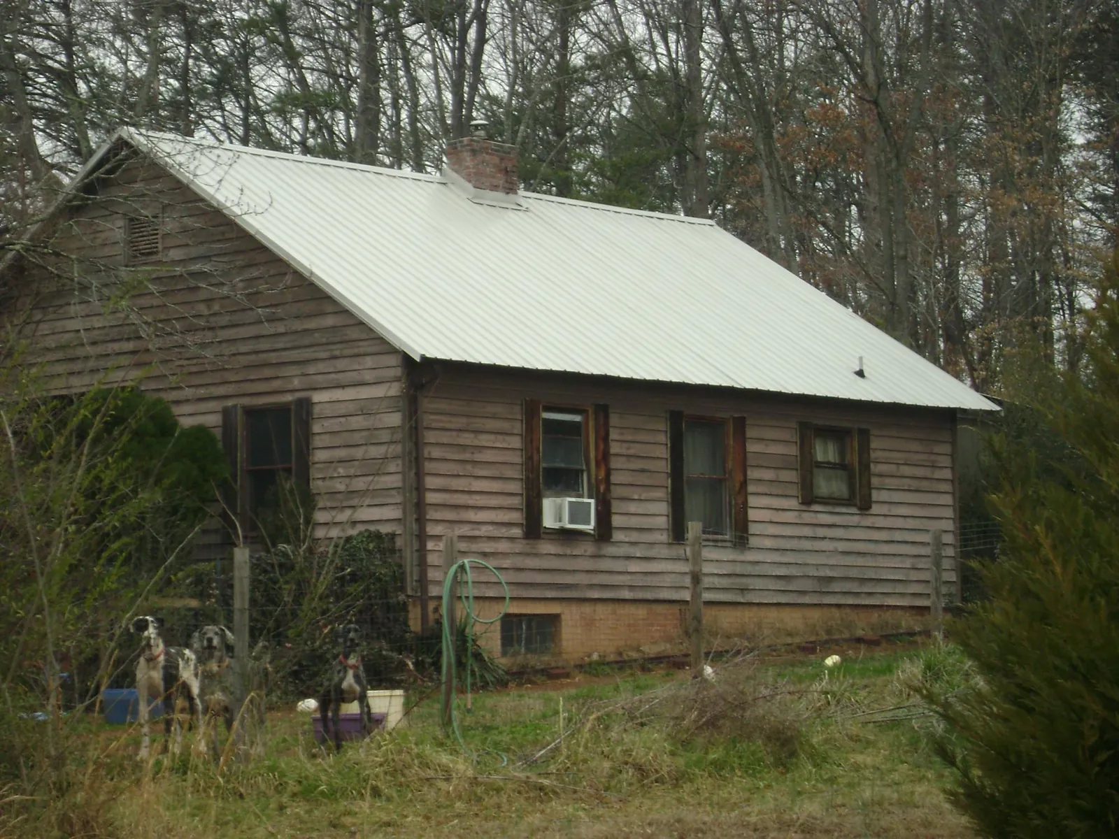 White metal roof on an old wood sided farmhouse, from a Metal Roof Installation job in Torrington